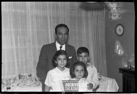 Casa de la familia López Arango, Canal 6 TV. Fiesta de cumpleaños. Hombre de terno, dos niñas y un niño posando para foto en fiesta de cumpleaños.